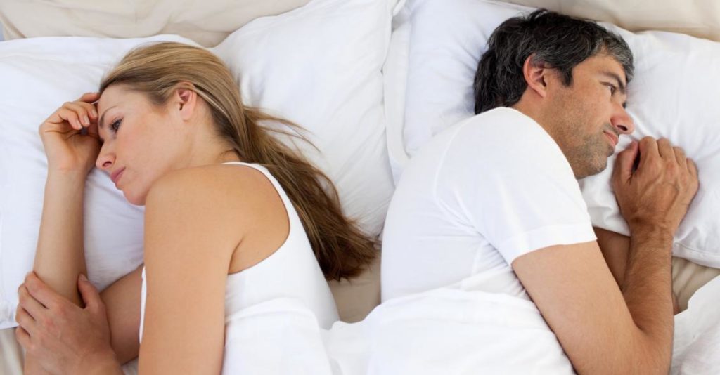 upset-couple-sleeping-separately