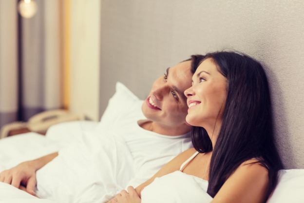 A happy couple in bed, an interdependency concept