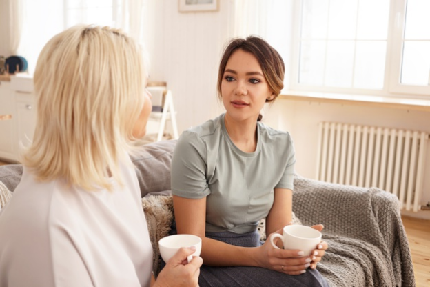 a woman hesitating to express her emotions to a friend