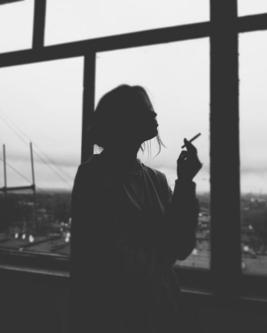 Silhouette of a woman smoking a cigarette