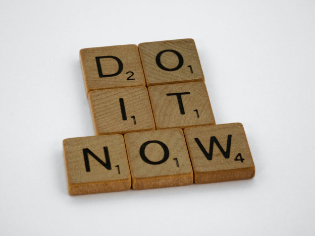 The words ‘Do It Now’ in wooden scrabble blocks