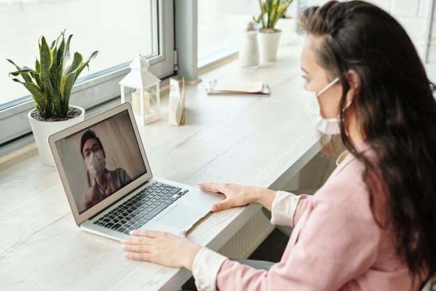 A woman having virtual consultation with her doctor