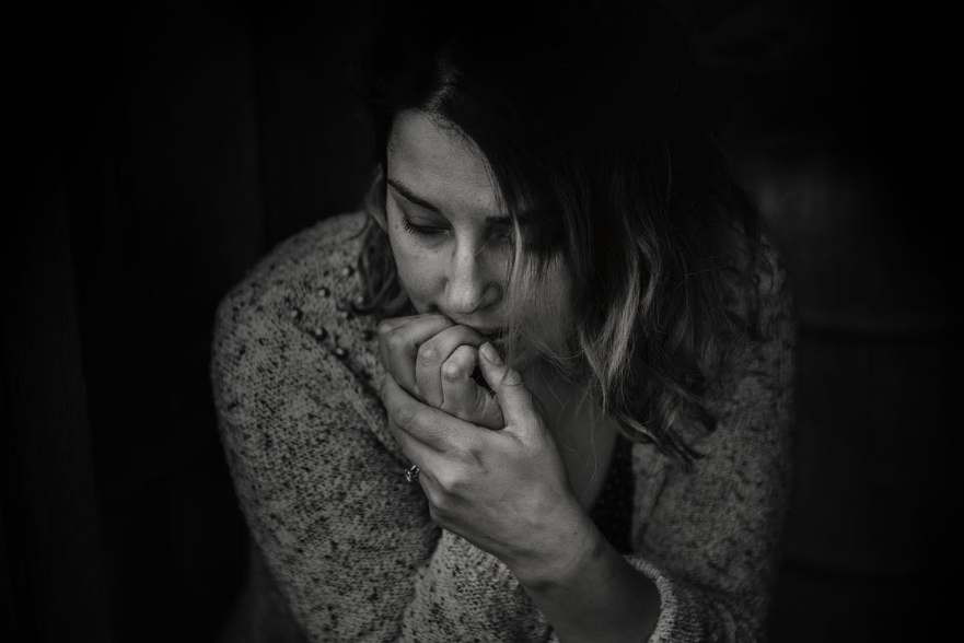 A greyscale photo of a woman experiencing fear