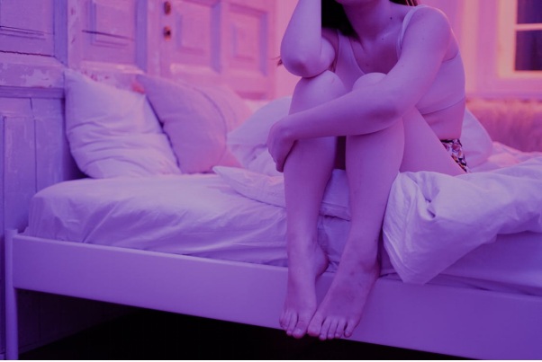 A Faceless Woman Sitting Up in Bed