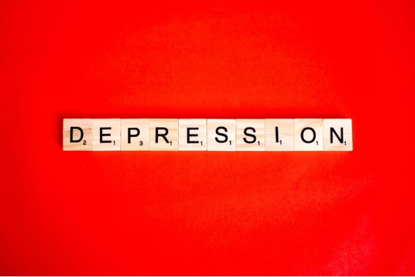 Depression Spelled Out with Scrabble Bricks Against a Red Background