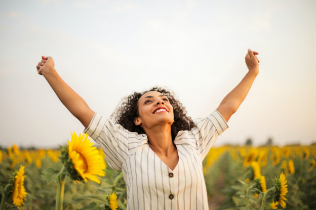 A woman standing in a sunflower field