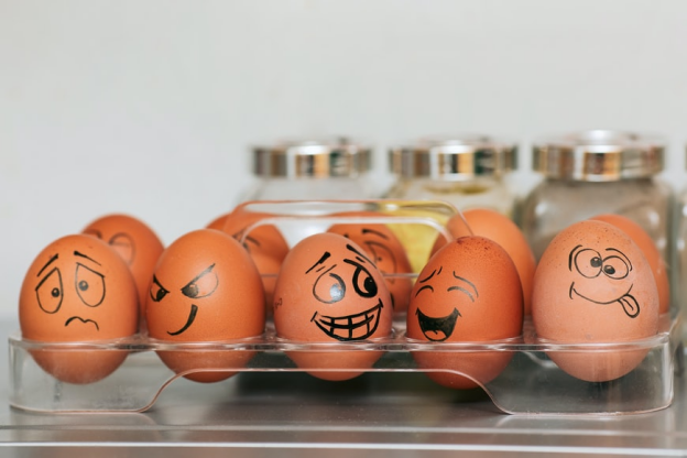 A Row Of Eggs With Hand Drawn Silly Faces