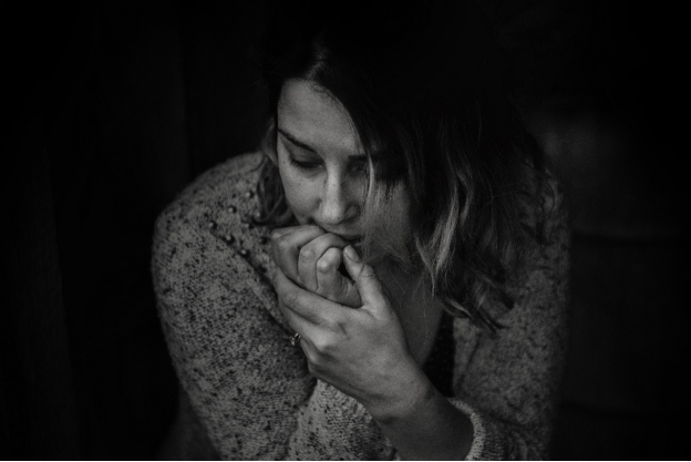 A woman sitting looking worried