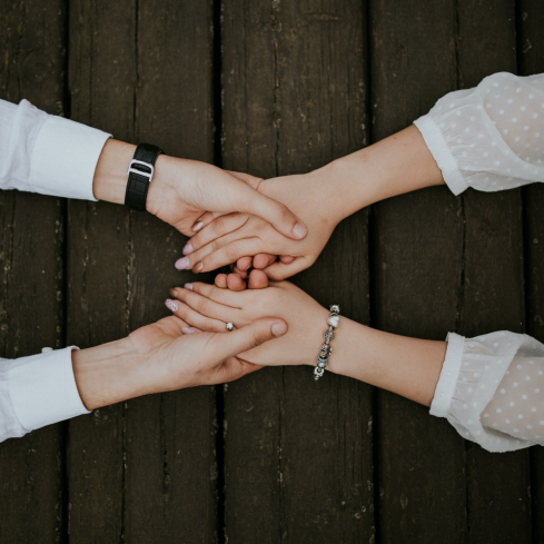 flat lay photography of man and woman holding hands