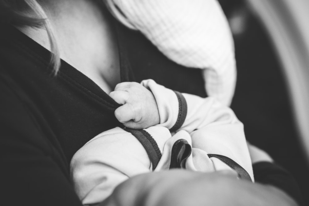 Grayscale image of a woman holding a child