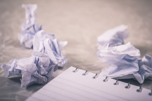 crumpled papers lying on a floor