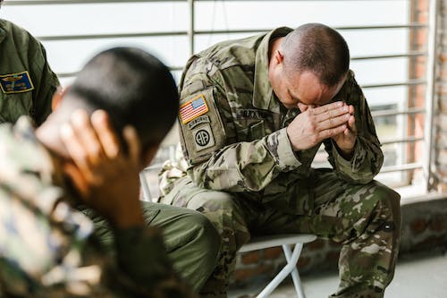 a man from the armed forces facing down