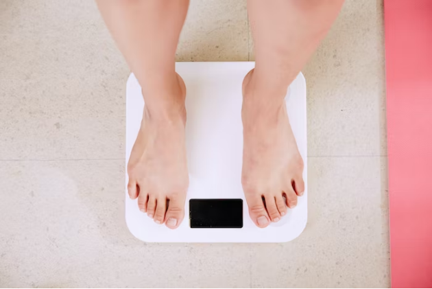 a person standing on a weighing machine