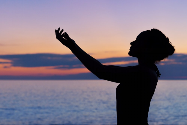 a woman standing by the ocean