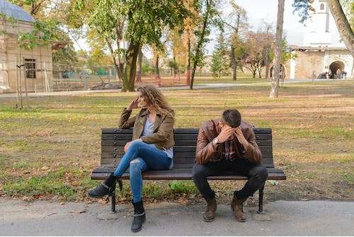 A couple sitting on a bench during an argument