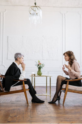 Two women sitting in front of each other