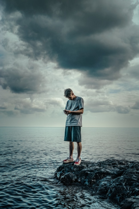 a person standing at the edge of the shore