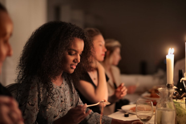 A person eating in a social setting