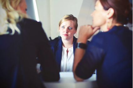 Three people sitting in professional attire