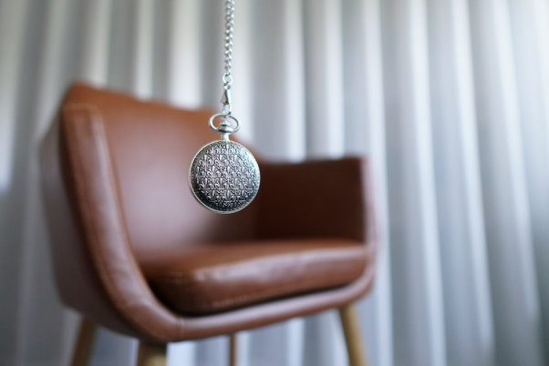 A balancing pendulum with a chair in the background