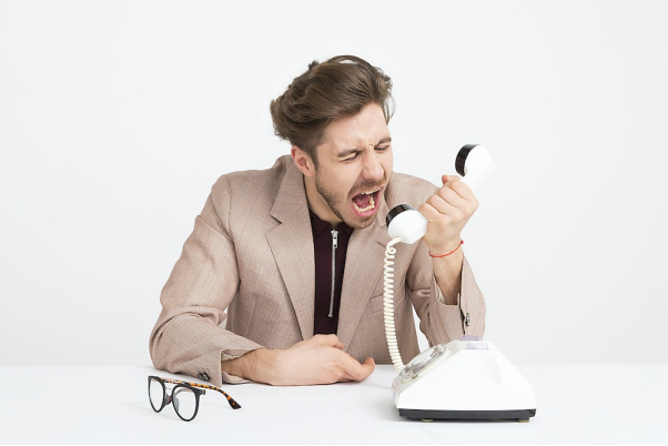 A person screaming on a telephone