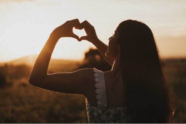 A person making a heart with their hands