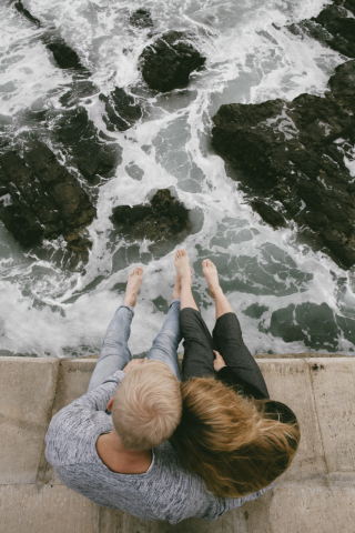 A couple sitting by the water